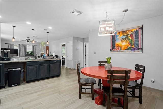 dining area featuring light wood finished floors, visible vents, and recessed lighting