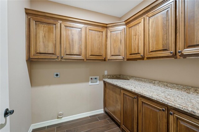 laundry room with wood tiled floor, hookup for an electric dryer, baseboards, cabinet space, and washer hookup