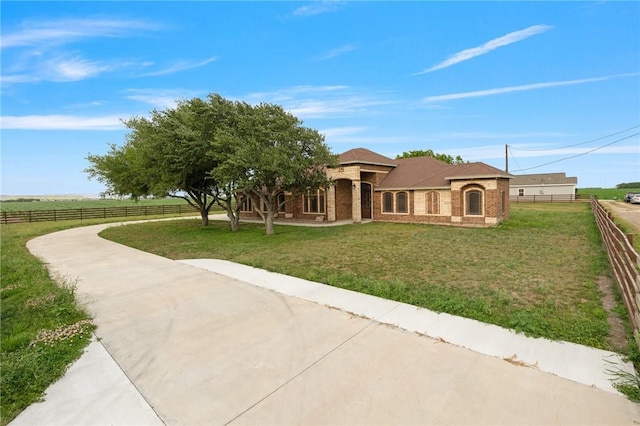 view of front of property with a front yard and fence