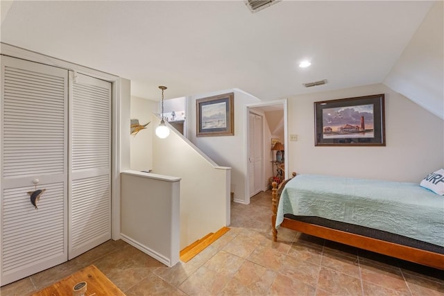 bedroom with a closet and vaulted ceiling