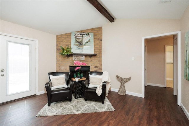 sitting room with vaulted ceiling with beams, a fireplace, wood finished floors, and baseboards