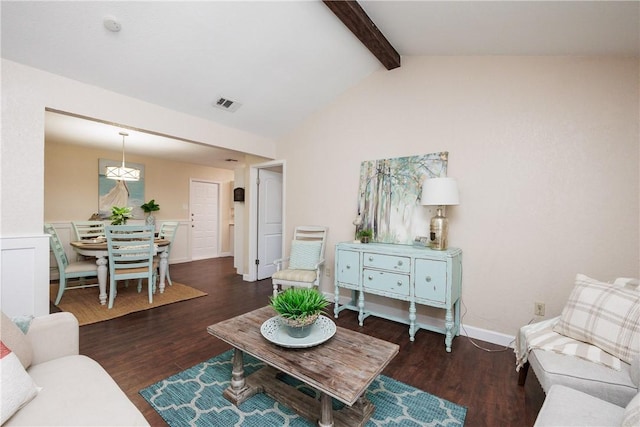 living room featuring visible vents, vaulted ceiling with beams, baseboards, and wood finished floors