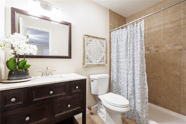 bathroom featuring a tile shower, vanity, and toilet