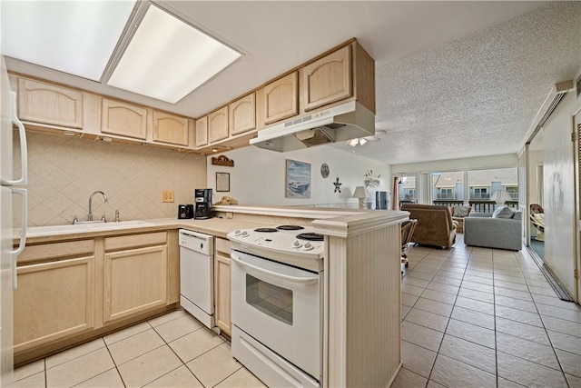 14810 Windward Dr Unit 301, Corpus Christi, TX 78418 - kitchen featuring white appliances, under cabinet range hood, light brown cabinets, light tile patterned floors, and light countertops