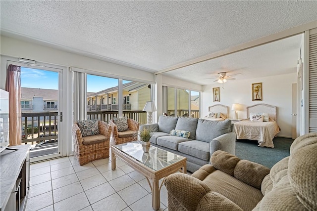 14810 Windward Dr Unit 301, Corpus Christi, TX 78418 - living room featuring a textured ceiling, ceiling fan, and light tile patterned floors