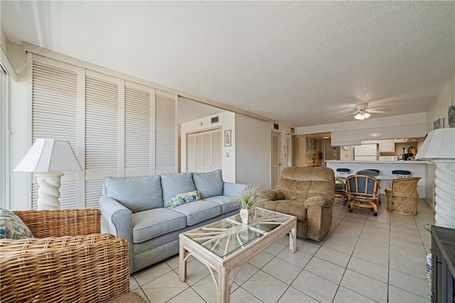 14810 Windward Dr Unit 301, Corpus Christi, TX 78418 - living area featuring a textured ceiling, light tile patterned flooring, and a ceiling fan