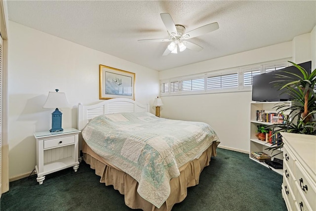 14810 Windward Dr Unit 301, Corpus Christi, TX 78418 - bedroom with dark carpet, a ceiling fan, and a textured ceiling