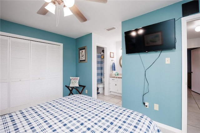 bedroom featuring visible vents, ensuite bathroom, a closet, light tile patterned floors, and ceiling fan