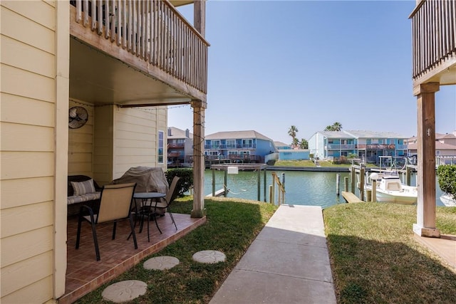 view of patio / terrace with a residential view, a water view, and a boat dock