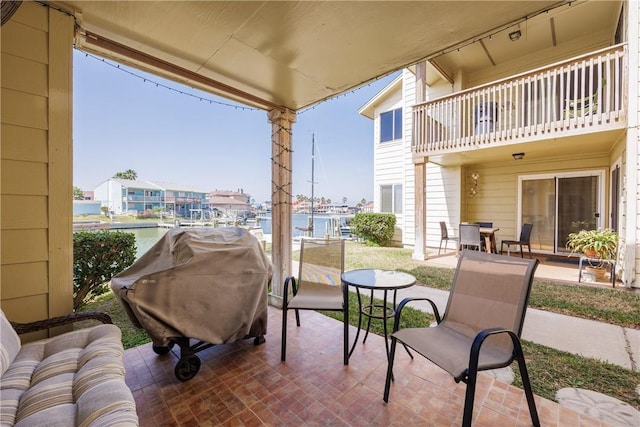 view of patio featuring a balcony and a grill