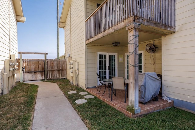 view of patio / terrace featuring a balcony, area for grilling, french doors, and fence