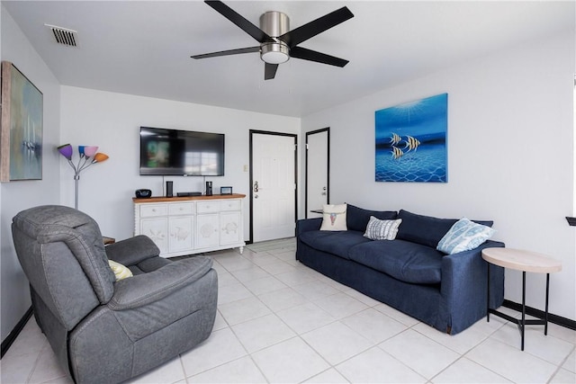 living room featuring light tile patterned floors, visible vents, baseboards, and ceiling fan