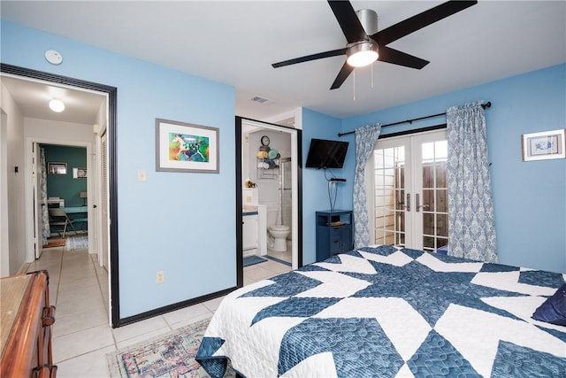 bedroom with ensuite bath, light tile patterned floors, french doors, and baseboards