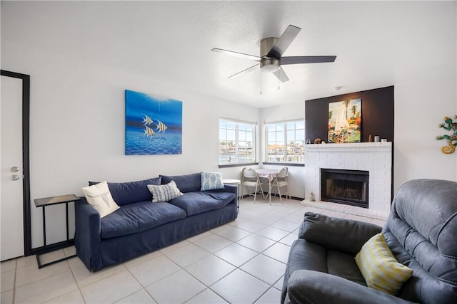 living room with light tile patterned flooring, a fireplace, and ceiling fan