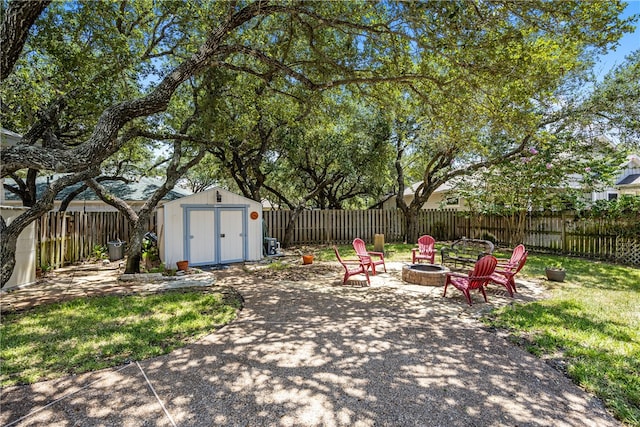 view of yard featuring a shed and a fire pit