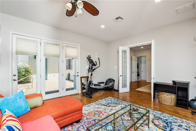 living room featuring hardwood / wood-style floors, ceiling fan, and french doors