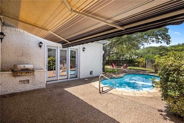 view of swimming pool featuring a patio area and grilling area