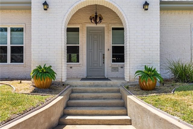 view of exterior entry featuring covered porch