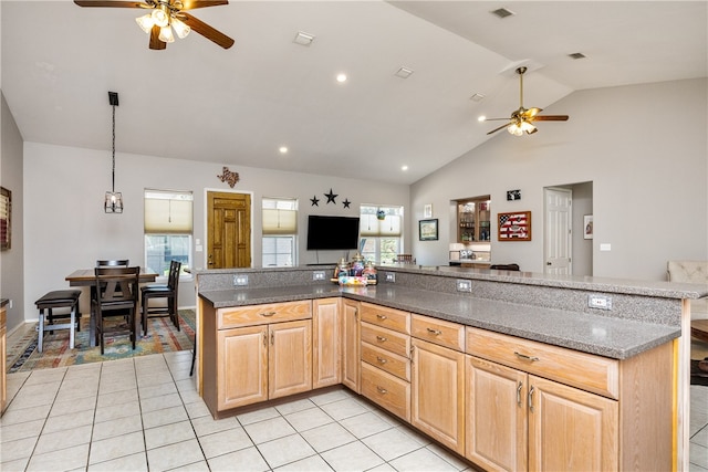 kitchen with plenty of natural light, dark stone counters, and light tile patterned floors