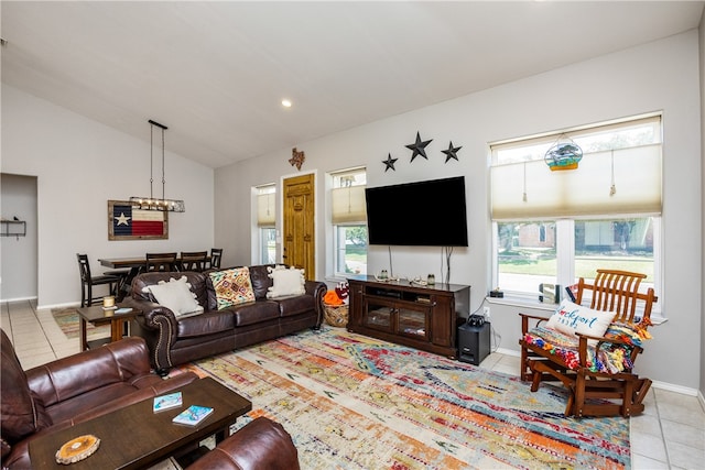 living room with lofted ceiling, light tile patterned flooring, and a chandelier