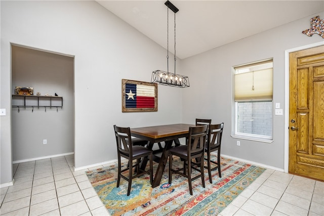 tiled dining space featuring vaulted ceiling