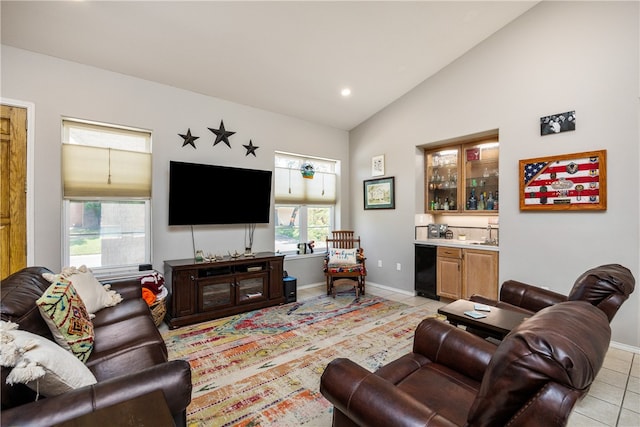 tiled living room featuring high vaulted ceiling and bar