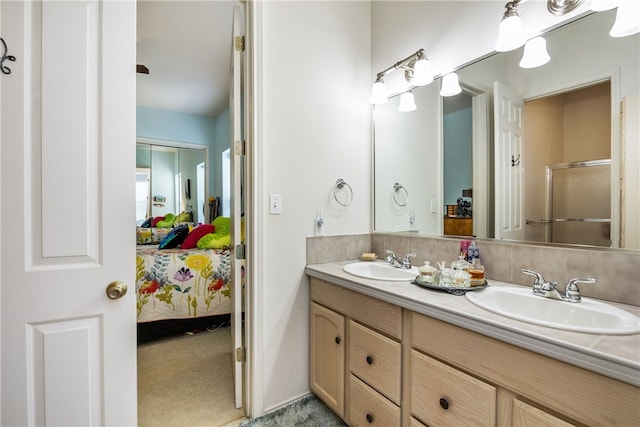 bathroom featuring vanity and a shower with door