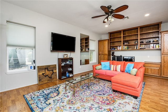 living room with hardwood / wood-style flooring and ceiling fan