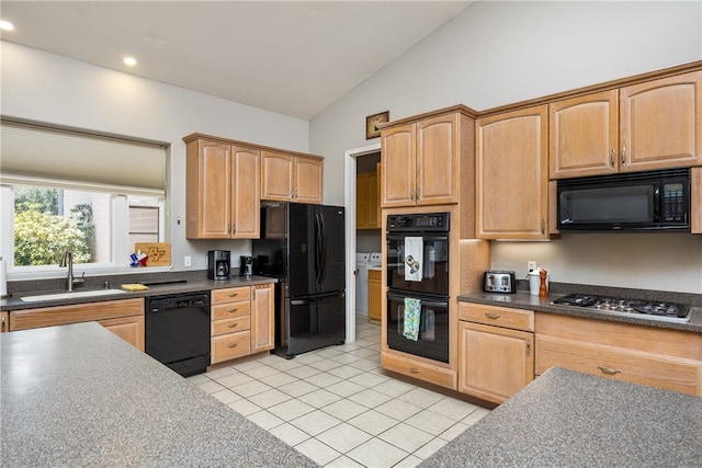 kitchen with black appliances, sink, vaulted ceiling, and light tile patterned flooring