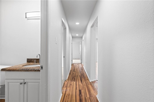 6106 Orangewood Dr, Corpus Christi, TX 78412 - hall with a sink, wood finished floors, recessed lighting, and baseboards