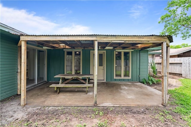 6106 Orangewood Dr, Corpus Christi, TX 78412 - rear view of property with a patio, fence, and board and batten siding