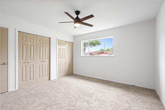 6106 Orangewood Dr, Corpus Christi, TX 78412 - unfurnished bedroom featuring two closets, carpet floors, a ceiling fan, and baseboards