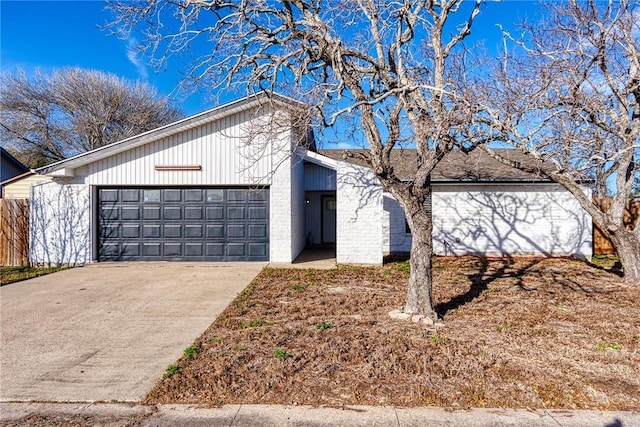 mid-century inspired home with driveway and an attached garage