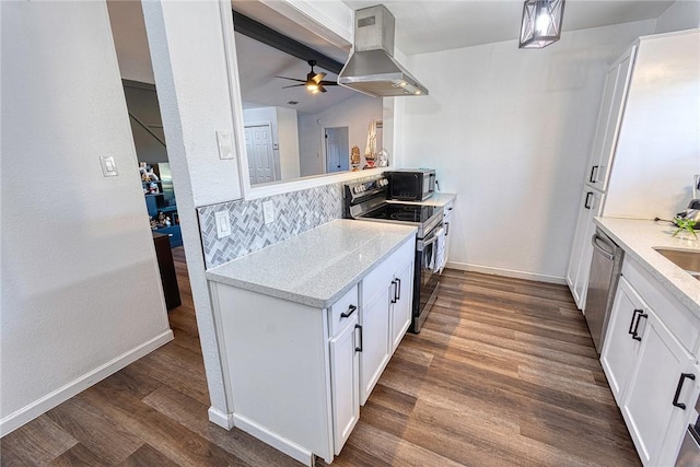 kitchen with dark wood finished floors, island range hood, range with electric cooktop, black microwave, and dishwasher