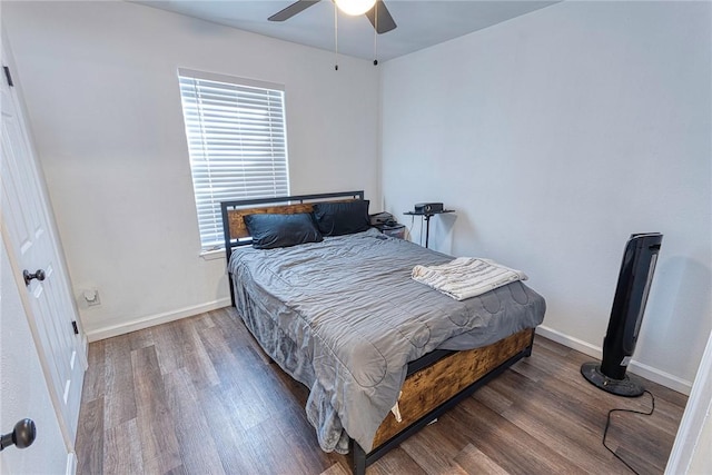 bedroom featuring ceiling fan, baseboards, and wood finished floors