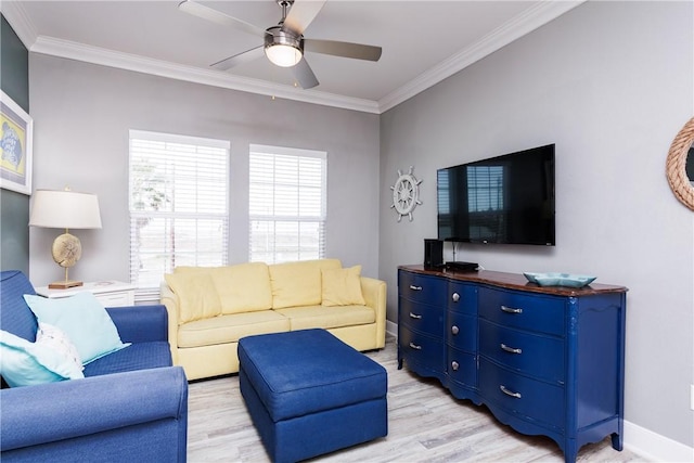 living room featuring light wood-style flooring, baseboards, ceiling fan, and ornamental molding