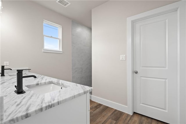 bathroom with vanity and hardwood / wood-style flooring