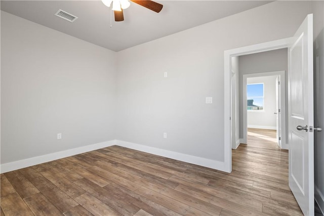 unfurnished room with ceiling fan and wood-type flooring