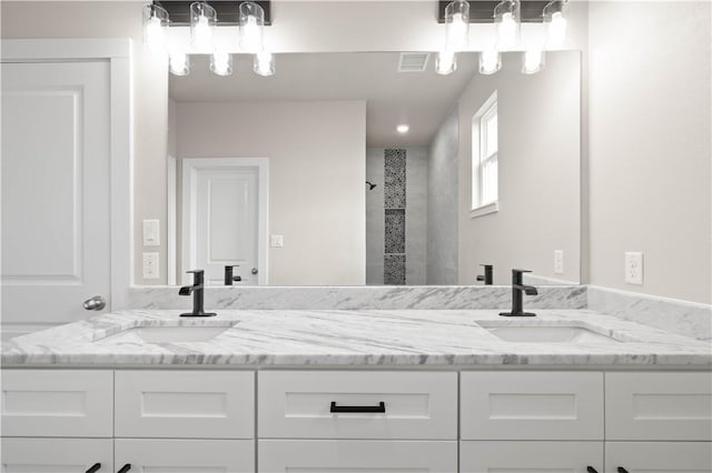 bathroom featuring vanity and a tile shower