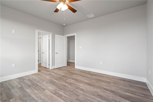 unfurnished bedroom featuring ceiling fan and light wood-type flooring