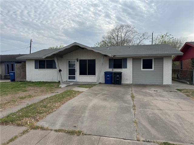 single story home featuring brick siding and fence