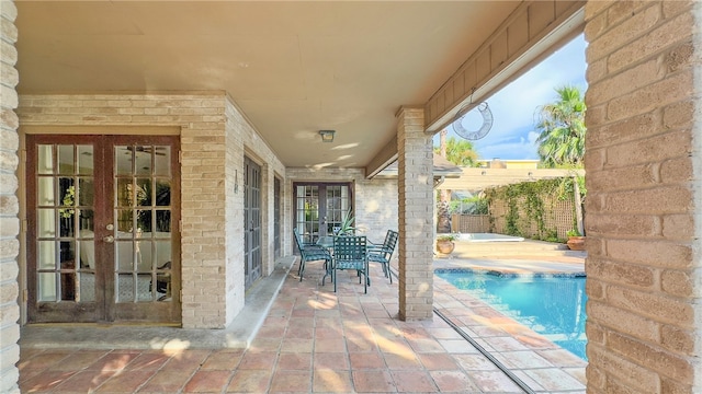 view of patio / terrace with french doors and a fenced in pool