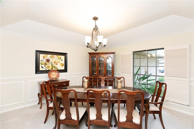 dining space featuring a chandelier, light carpet, and crown molding