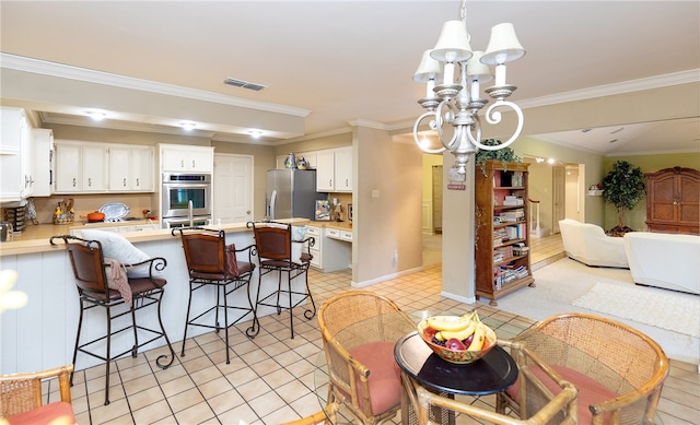 tiled dining space with a notable chandelier and crown molding