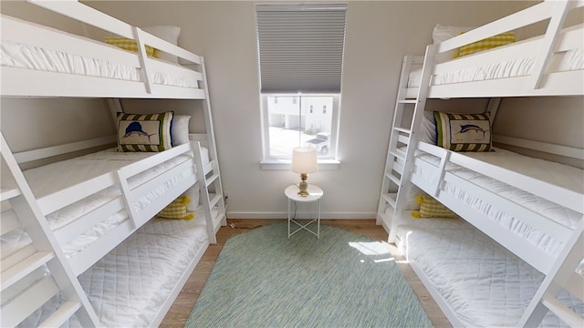 bedroom featuring baseboards and wood finished floors