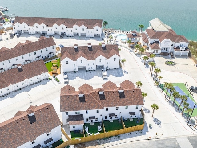 drone / aerial view with a water view and a residential view