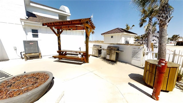 view of patio with fence, grilling area, and a pergola