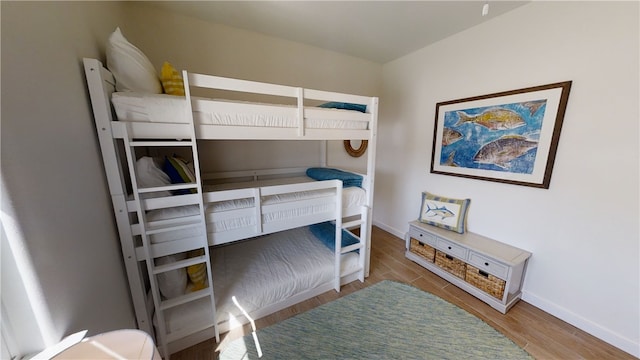 bedroom featuring baseboards and wood finished floors