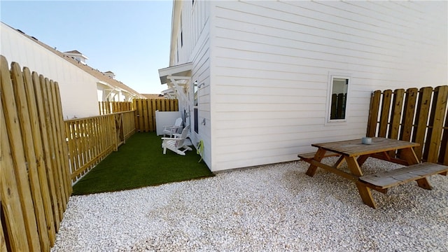 view of home's exterior with a patio area, a fenced backyard, and a yard