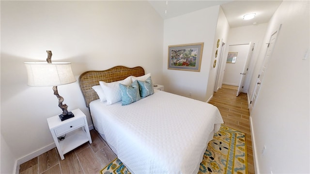 bedroom with wood tiled floor and baseboards